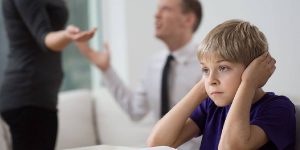 A distressed child caught in the middle of arguing parents, extramarital affairs being the source of the dispute.